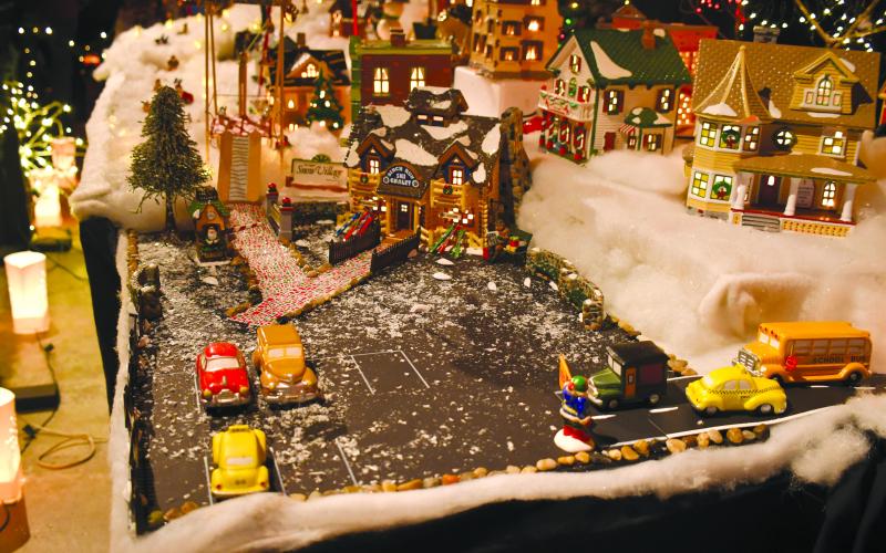 Megan Broome/The Clayton Tribune. This snowy village is part of the incredible indoor miniature village display at the Christmas Village of lights. Families went through the many displays offered inside and completed a scavenger hunt through the village.