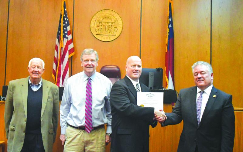 Megan Broome/The Clayton Tribune. Magistrate Judge James V. Blalock takes the oath of office on Dec. 29, 2022, at the Rabun County Courthouse. Pictured with Blalock are Judge Carlton H. Jones III and Judge  C. Crandle Bray, who will serve as assistant magistrate judges to Blalock during the same four-year term; and Judge Russell W. Smith, who administered the oath of office to Blalock.