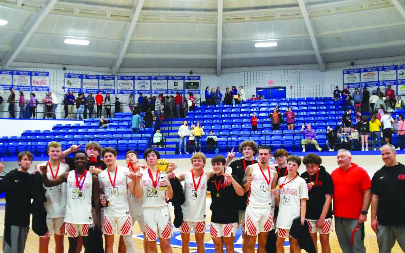 Enoch Autry/The Clayton Tribune.  Senior Jayton Henry holds the trophy after he and his Rabun County Wildcat teammates defeat Union County 54-53 on Dec. 30 for the Battle of the States championship.