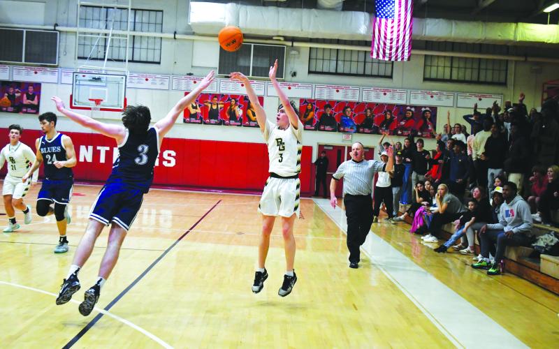Luke Morey/The Clayton Tribune. With Rabun Gap students in the background, senior Theo Antinori knocks home a late three to put the Eagles within two points against Asheville. The Eagles fell 67-64 in their first game of the 2023 season.