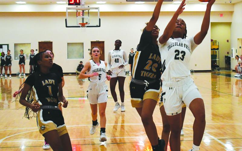 Luke Morey/The Clayton Tribune. TFS senior Denika Lightbourne finishes a basket through contact on Friday, Jan. 13 against Commerce. Lightbourne finished with 31 points on Friday night.