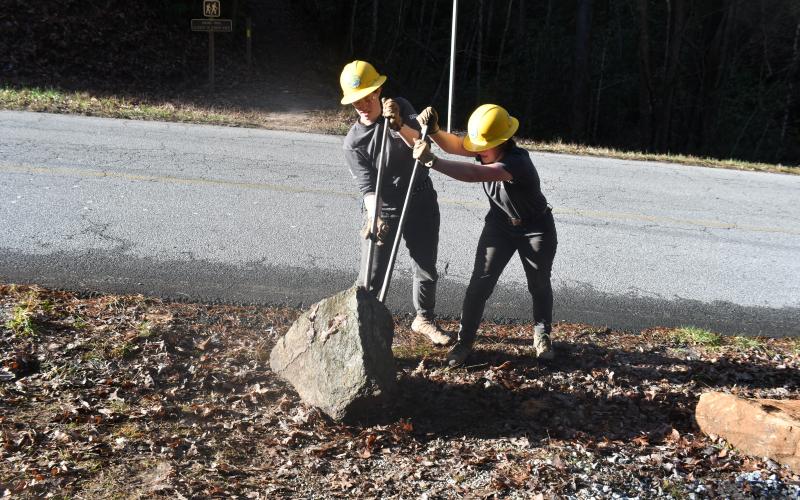 Megan Broome/The Clayton Tribune. Crew members with the Southeast Conservation Corps work together to carry large and heavy stones to a portion of the Bartram Trail at Warwoman Dell in order to build a set of stone stairs on the popular and highly-used trail.