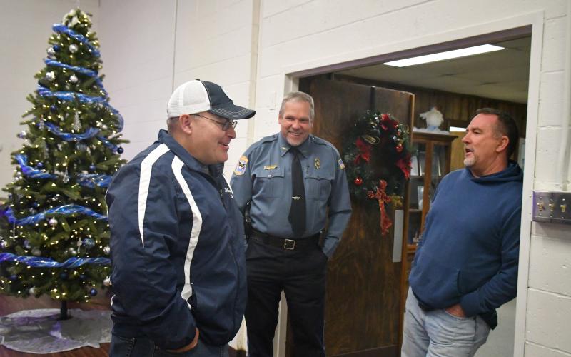 Megan Broome/The Clayton Tribune. Mountain City Police Chief Tom Garrison, center, talks with Jeremy Welch and Mark Wannamaker at Garrison’s retirement reception on Dec. 30, 2022. Garrison retires after serving as a law enforcement officer for 28 years and Mountain City Police Chief for 18 years. Welch was tapped as Interim Police Chief.