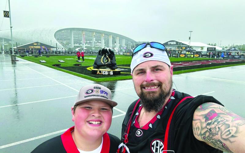 Selfie photo courtesy Ron Baumes. Michael Baumes, 11, and his father Ron made the cross-country trip in a car to watch the Bulldogs win the title in Inglewood, Calif.