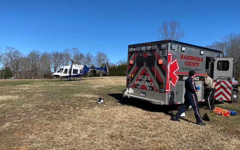 Habersham County photo/Rob Moore. Habersham County Emergency Services personnel, assisted by the flight crew from AirLife Georgia 14, provide care to an injured Rabun Gap man on Feb. 6 after they worked to free him from a tree in Clarkesville, Ga. The man died the next day as a result of injuries sustained.