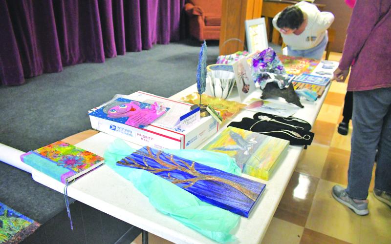Megan Broome/The Clayton Tribune. Over 20 members of the North Georgia Arts Guild displayed their works at the annual Members Show and Tell themed “Winter Blues” during the organization’s meeting Feb, 16. Artists gave presentations for each of their works, describing the medium and inspiration behind them, then displayed them for other Guild members to observe and converse about during the meeting.