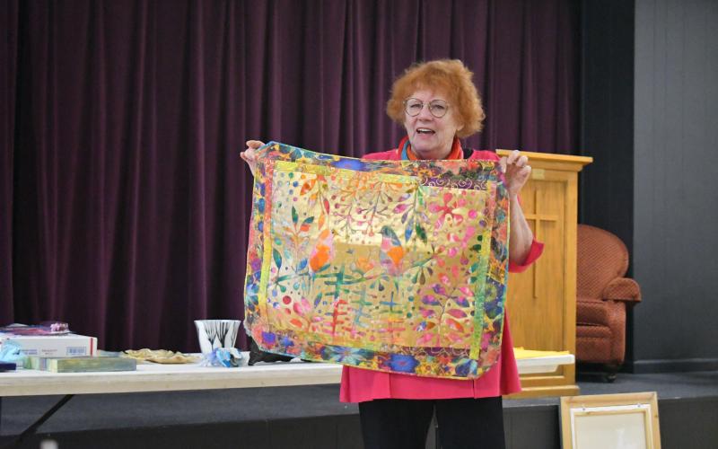 Megan Broome/The Clayton Tribune. North Georgia Arts Guild member Silke Cliatt showcases her art piece at the Feb. 16 Members' Show and Tell.
