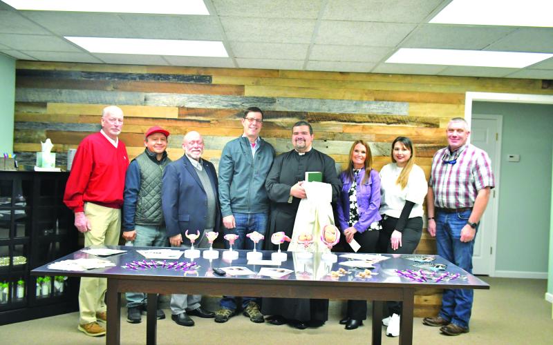 Megan Broome/The Clayton Tribune. Matt Mitcham, Rotary Club of Clayton member; Gustavo Munoz; Dr. Paul Thigpen, Choices Pregnancy Center Board of Directors member and member of the Knights of Columbus at St. Helena Catholic Church; Eric Vogelbacher, Grand Knight for the Knights of Columbus, Choices Advisory Board member and Rotary Club of Clayton member; Father Luis Alvarez; Carla Wright, executive director of Choices Pregnancy Center; volunteer Kayla Scott; and Sheriff Chad Nichols.