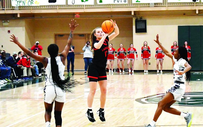 Luke Morey/The Clayton Tribune. RCHS junior Lucy Hood hits a shot as two Elbert defenders rush out to the three-point line. Elbert County won the Region 8 title 61-41 on Friday, Feb. 17. The No. 2 Lady Cats took on Pepperell on Tuesday, Feb. 21, in the first round of the GHSA state playoffs.