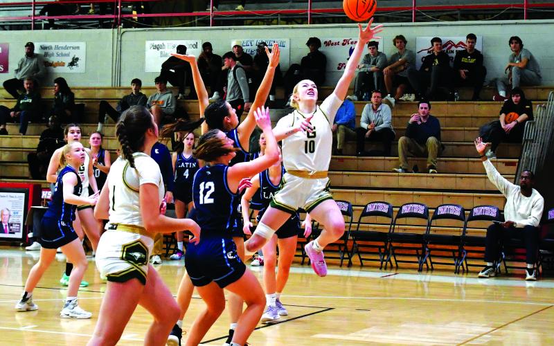 Luke Morey/The Clayton Tribune. Rabun Gap junior Monna Julkunen finishes through contact against Charlotte Latin on Saturday, Feb. 18. Julkunen scored 13 points, helping lead the Lady Eagles to a 63-33 victory, advancing to the NCISAA state semifinal round against Providence Day School on Feb. 21.