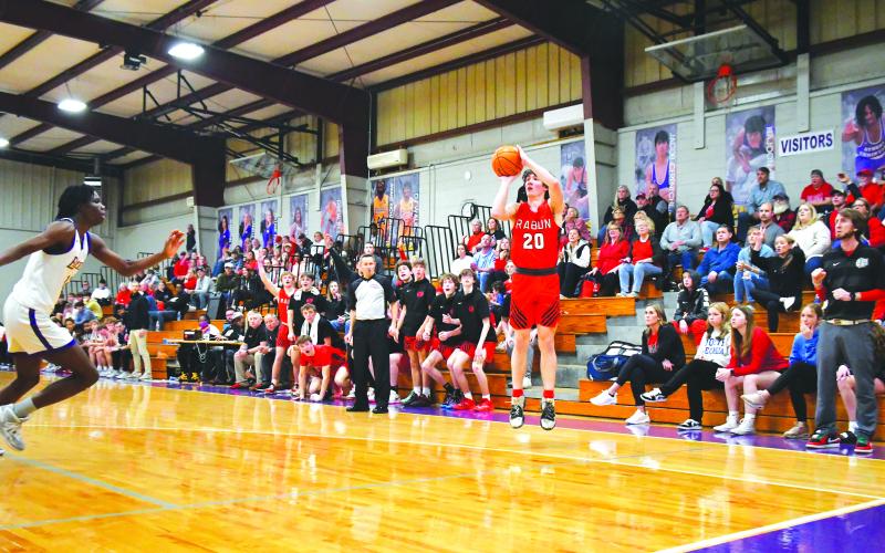Luke Morey/The Clayton Tribune. RCHS senior Jayton Henry hits his second three in the fourth quarter of the region championship game against Athens Christian on Saturday, Feb. 18. Athens Christian held onto a three-point victory to secure the region title, with the No. 2 seed WIldcats hosting Trion on Tuesday, Feb. 21, for the first round of the GHSA state playoffs.