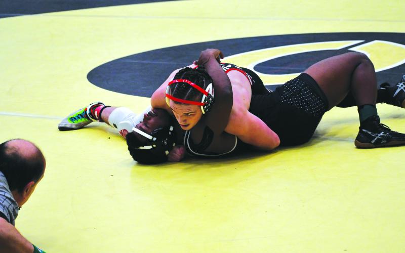 Luke Morey/The Clayton Tribune. RCHS senior Miles Watts looks at the referee waiting for him to declare a pin on Kevin Maven-WInchester from St. Francis during the sections tournament on Saturday, Feb. 11. Watts took second place in sectionals, now traveling to Macon for another chance to place at state after taking second place last year and first place in state his sophomore year.