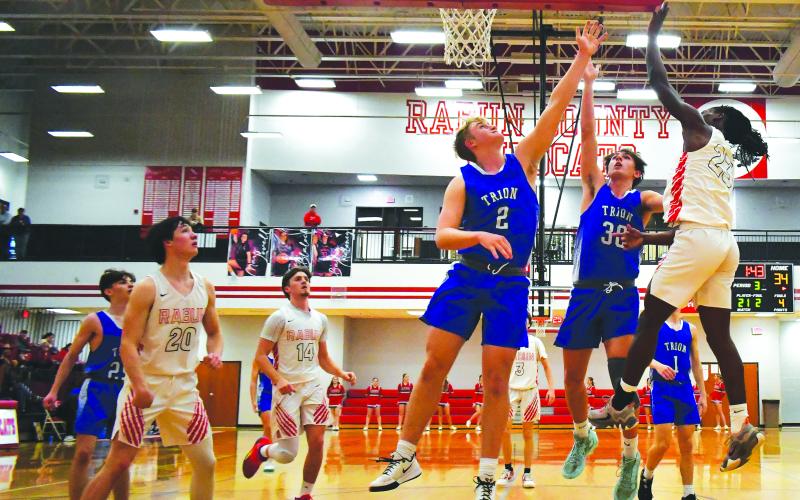 Luke Morey/The Clayton Tribune. RCHS junior Willie Goodwyn collects a rebound and puts the shot back in on Tuesday, Feb. 21 against Trion in the first round of the GHSA State Playoffs. Goodwyn helped stave off a late comeback, with 25 points to propel the Wildcats into the Sweet Sixteen.