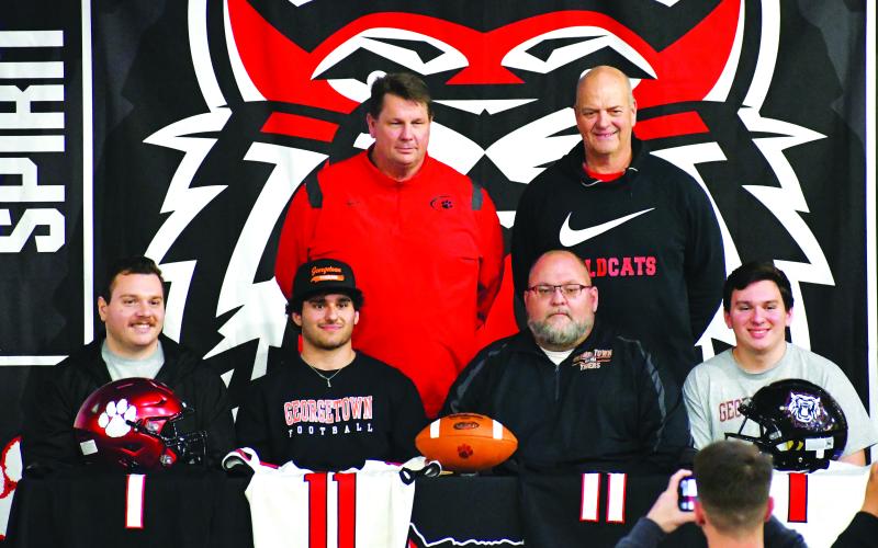 Luke Morey/The Clayton Tribune. Baloga with his family (Zac, father Gregory, and Jacob) with RCHS head coach Michael Davis (standing left) and linebackers coach Jim Pavao.
