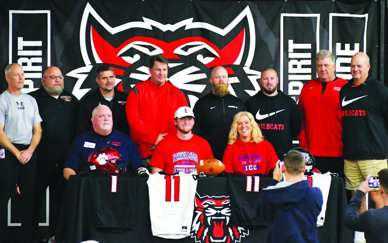 Luke Morey/The Clayton Tribune. Keegan Stover signed with Itawamba Community College in Mississippi on Wednesday, Feb. 1. Seated with Stover are parents Craig and Gail. Standing from left to right are coaches: Tim Corbett, Gregory Baloga, Ricky Ross, Michael Davis, Caleb Bagley, Clay Worley, Eric Richeson, and Jim Pavao.