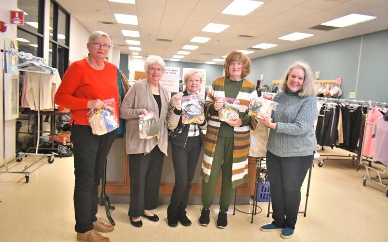 Megan Broome/The Clayton Tribune. Volunteers at First Impressions, a work-need ready clothes closet in Clayton, hold up “Blessing Bags” created by children at Wolffork Baptist Church in Rabun Gap to hand out to homeless people in Rabun County to help serve their needs. Pictured are Regina Sulley; Judy McCracken of Wolffork Baptist Church; Donna Pruitt; Karen Carroll; and Janine Bethel.