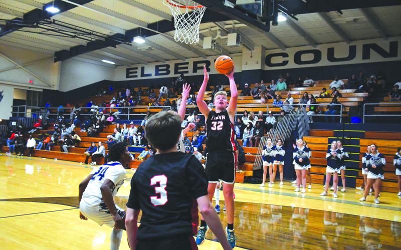 Luke Morey/The Clayton Tribune. RCHS’s Jack Hood puts in two of his dozen points at Elbert County.