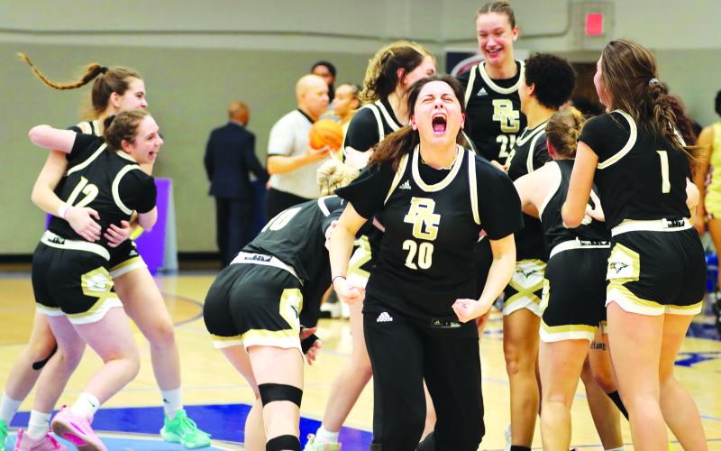 RGNS Athletics. Rabun Gap-Nacoochee School senior Ece Arabacioglu (20) celebrates a second straight state championship with her Lady Eagle teammates in the background on Saturday, Feb. 24. The Lady Eagles secured back-to-back state titles with a 53-43 victory over Cannon School at Calvary Day School. RGNS finished the season with a 25-7 record.