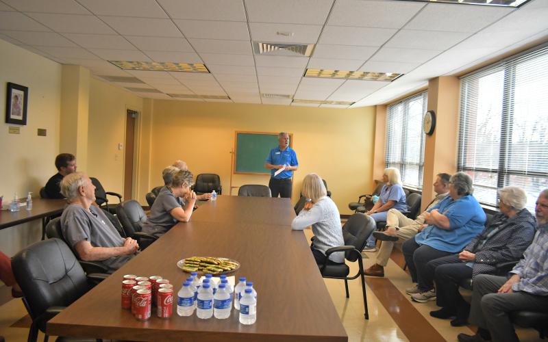 Megan Broome/The Clayton Tribune. Rotarian Tim Ranney, chair of Clayton Rotary Foundation, Inc., speaks to a group of people at a dedication event at the Community Dental Clinic, located at the Rabun County Health Department, honoring the late Rotarian Robert “Bob” Noble Fink who was instrumental in establishing the dental clinic. Ranney unveiled a memorial plaque that is displayed in the lobby of Community Dental to honor Fink.
