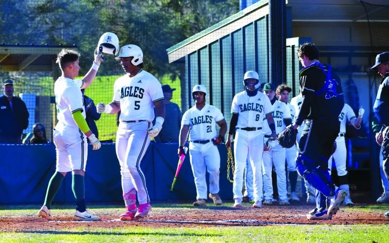 Luke Morey/The Clayton Tribune. Keilin Sanders congratulates Armani Guzman (5) after Guzman’s home run that brought Sanders home in the home opener on Thursday, March 15. Guzman and Sanders helped lead the Eagles to a 15-0 victory in three innings. The Rabun Gap Eagles, after a season where they went to the Final Four, have gotten off to a 8-0 start to the season. The Eagles take on Tallulah Falls at home on Thursday, March 23.