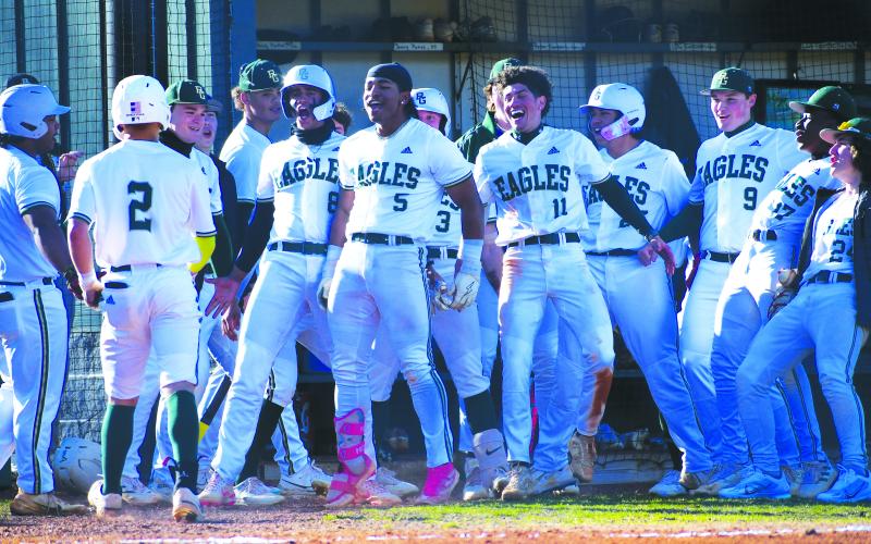 Luke Morey/The Clayton Tribune. The Rabun Gap-Nacoochee baseball team celebrates a home run scored by Armani Guzman (5).