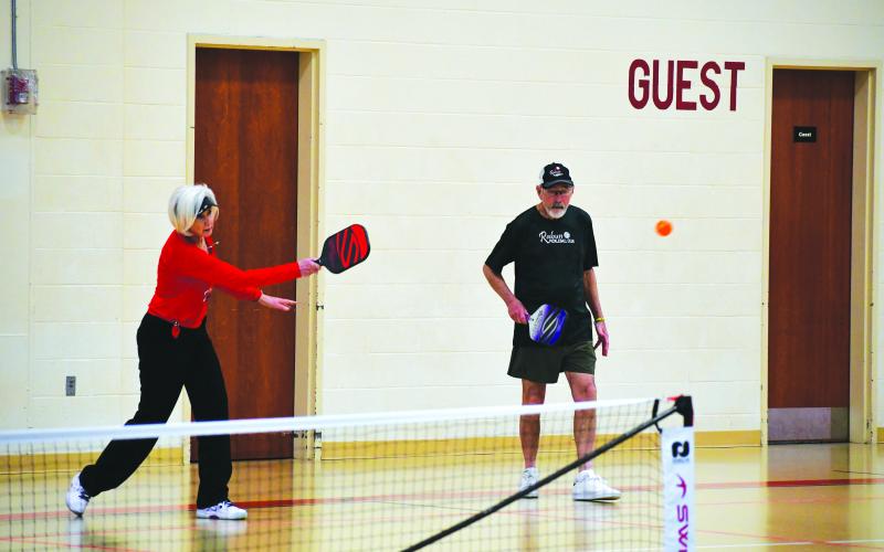 Photography by Tribune staff and Rabun County Recreation Department staff. Rabun Pickleball Club President Larry Walker looks on as his doubles partner Linda Lincoln returns a serve during this month’s Battle of the Paddles. Walker and Lincoln secured the gold medal for the mixed doubles 3.5 skill level at the 70 age bracket.