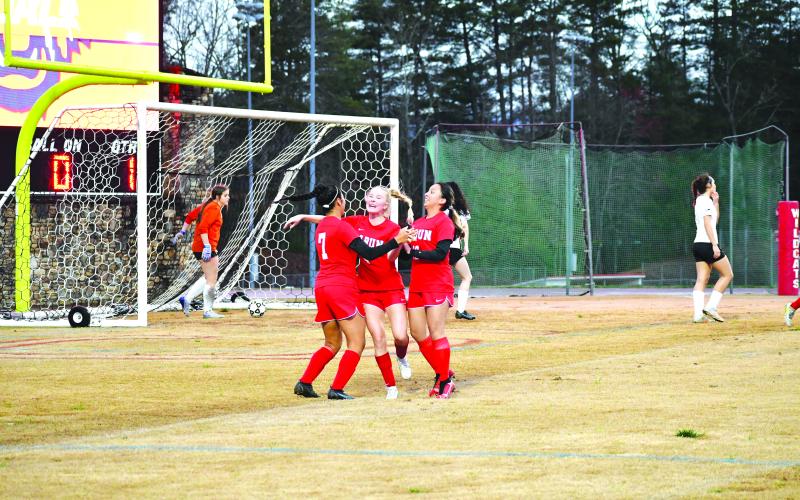 Luke Morey/The Clayton Tribune. Lady Cat Abby Sego (center) celebrates with Quetzaly Diaz, 7, and Aurora Barcenas after Diaz’s goal against Hart County on Thursday, March 2. The Lady Cats fell to Tallulah Falls on Tuesday, March 7. The RCHS girls next travel to take on Athens Christian on Friday, March 10, to start a three-game road trip.