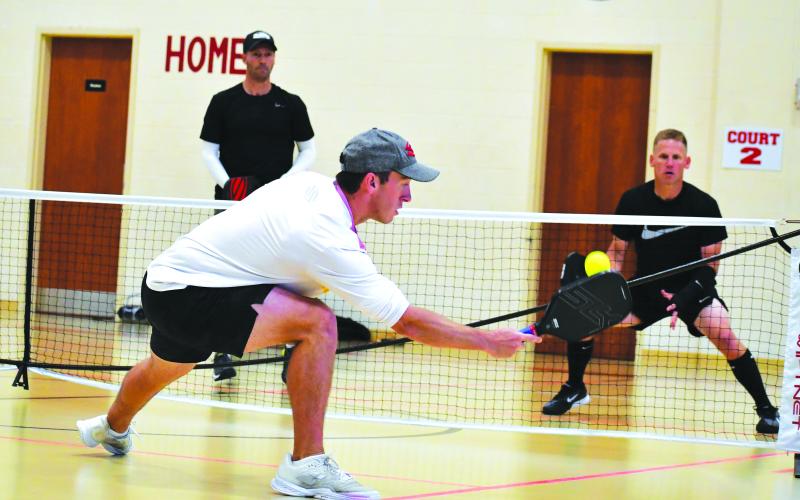 Luke Morey/The Clayton Tribune. Shea Underwood returns a shot against Mark Price and David Hebert.