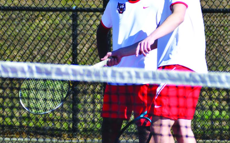 Luke Morey/The Clayton Tribune. Doubles partners Om Patel (left) and Jayton Henry discuss strategy during a match.