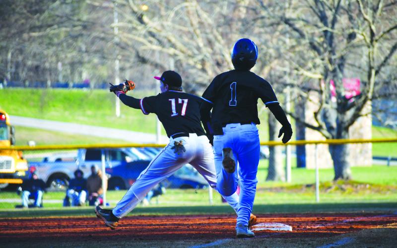 Luke Morey/The Clayton Tribune. Rabun County sophomore first baseman Elvis Hunt completes an out against Elbert County on Tuesday, March 14.