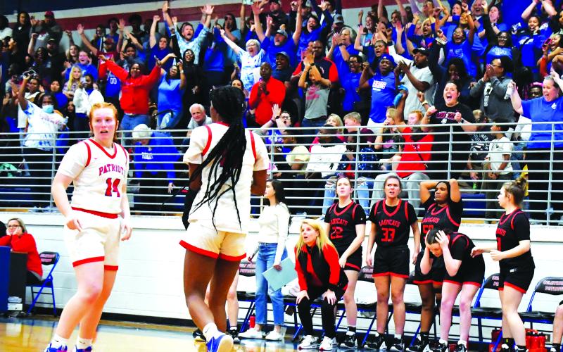Luke Morey/The Clayton Tribune. With a jubilant Oglethorpe crowd behind them, Rabun County head coach DeeDee Dillard and the Lady Cat bench react to a last second travel call on Friday, Feb. 24. The Lady Cats lost to Oglethorpe County 51-50, ending their season in the Sweet Sixteen.