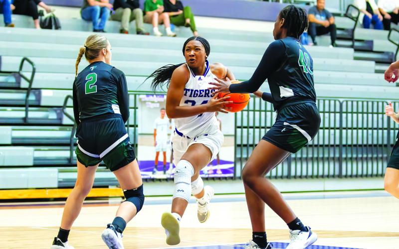 Kerry Gordon/Rome News-Tribune. Darlington's Jy Johnson attacks the paint against Tallulah Falls School defenders Breelyn Wood (2) and Tanisha Seymour in the first round of the GHSA state playoffs in Rome on Feb. 22. Darlington won 57-36 as the visiting Lady Indians saw their season come to a close, finishing with a 7-17 record, led by Region Player of the Year Denika Lightbourne.