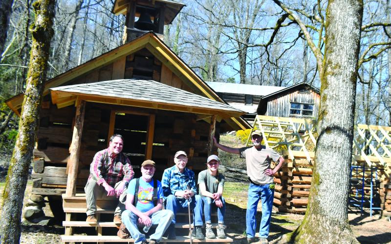 Megan Broome/The Clayton Tribune. Todd Faircloth, executive director of Foxfire (left); Tommy Thompson, volunteer; Kermit Rood; Kami Ahrens, curator and director of education for Foxfire; and Barry Stiles, museum director, sit in front of the miniature Chapel as the newest completed building in the Children’s Village.