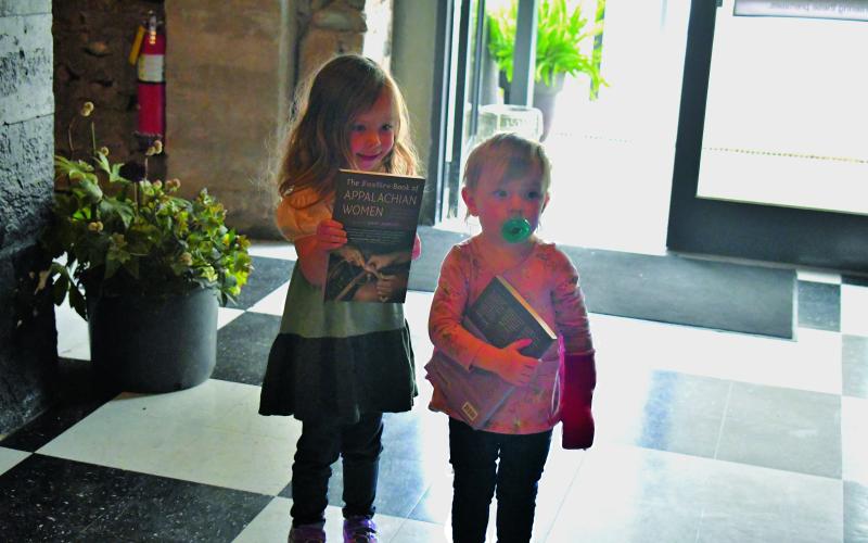 Megan Broome/The Clayton Tribune. Amberlee Sanders, age 1 and Scarlett Sanders, age 2, show their support and attend the Foxfire March 11 book launch event for the book “The Foxfire Book of Appalachian Women: Stories of Landscape and Community in the Mountain South,” which was written and edited by Kami Ahrens, curator and director of education for Foxfire.