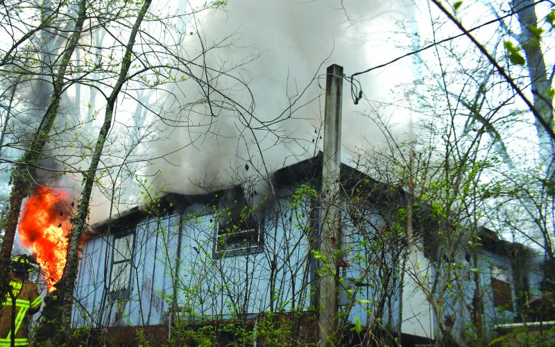 Megan Broome/The Clayton Tribune. Rabun County Fire Services deploys defensive and offensive tactics to knock down a structure fire at 338 Turpin Street in Tiger March 2. The structure was determined to be a complete loss.