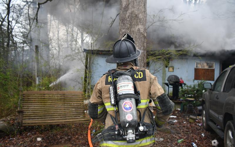 Megan Broome/The Clayton Tribune. Rabun County Fire Services deploys defensive and offensive tactics to knock down a structure fire at 338 Turpin Street in Tiger March 2. The structure was determined to be a complete loss.