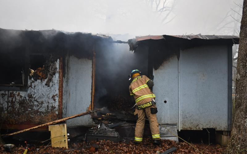 Megan Broome/The Clayton Tribune. Rabun County Fire Services deploys defensive and offensive tactics to knock down a structure fire at 338 Turpin Street in Tiger March 2. The structure was determined to be a complete loss.