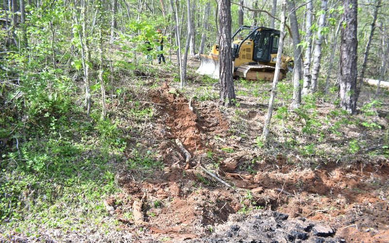 Megan Broome/The Clayton Tribune. Georgia Forestry Commission uses its bulldozer on scene for a wildfire at Bettys Creek and Colony Road in Dillard.
