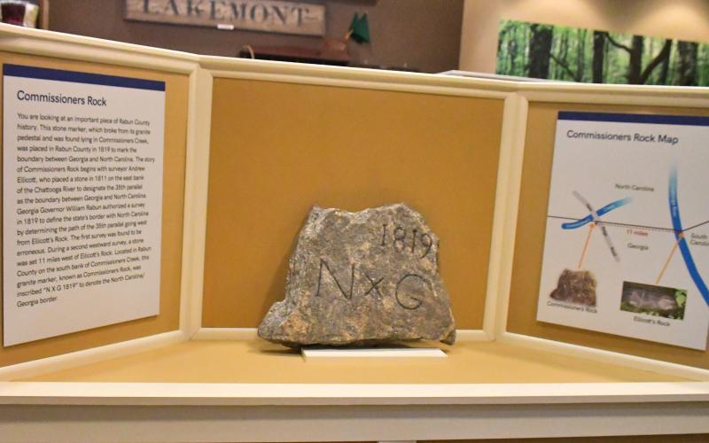 Megan Broome/The Clayton Tribune. Commissioners Rock, which depicts a surveying monument marking the boundary between Georgia and North Carolina dating back to 1819, is now on display at the Rabun County Historical Society.