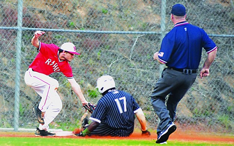 Luke Morey/The Clayton Tribune. Rabun County sophomore Parker Smith tags Zaiden Cox during a home game on Tuesday, April 4.