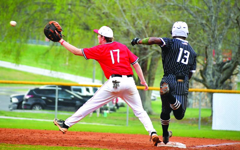 Luke Morey/The Clayton Tribune. Tallulah Falls senior Frankey Moree beats out a throw to Rabun County first baseman Elvis Hunt on Tuesday, April 4. Moree and the Indians have now clinched a playoff berth with six games remaining in the regular season.