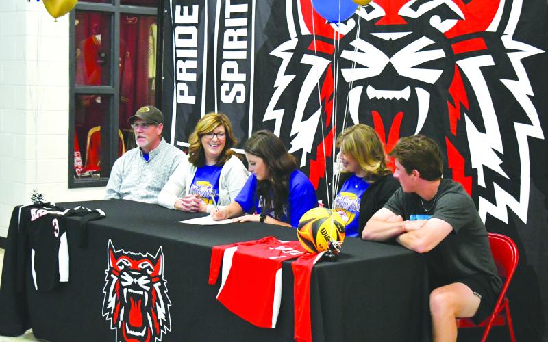 Luke Morey/The Clayton Tribune. On Monday, April 24, RCHS senior Abbye Carver signed her collegiate letter to play beach volleyball at Emmanuel College. Pictured from left, father Jim Carver, mother Tori Carver, Abbye, sister Miranda Hunnicutt and brother Grayson Carver.