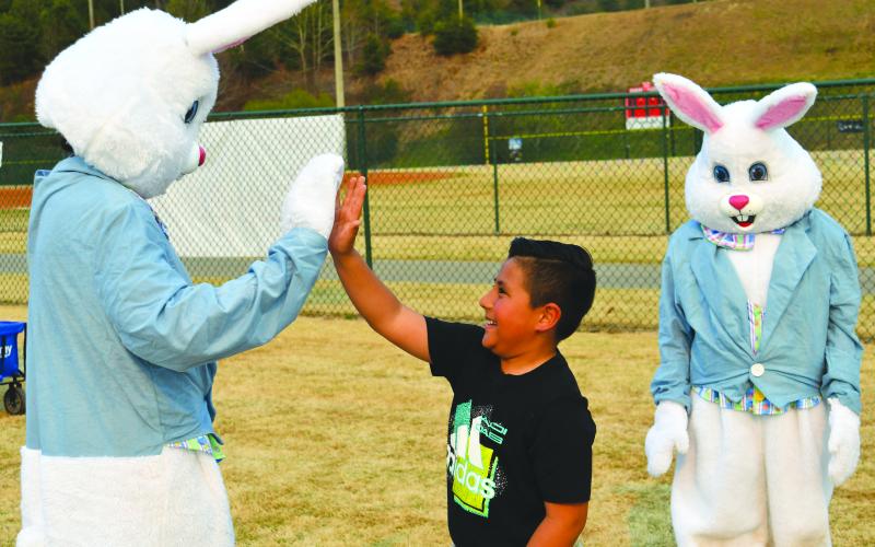 Seven-year-old Dylan Lozada gives one of the three Easter bunnies a high-five at the Rabun County Recreation Department’s Annual Easter Egg Hunt event on March 30 at the sports complex. The afternoon was filled with lots of fun.
