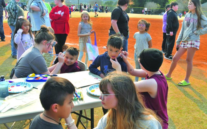 Children get their faces painted at the event.