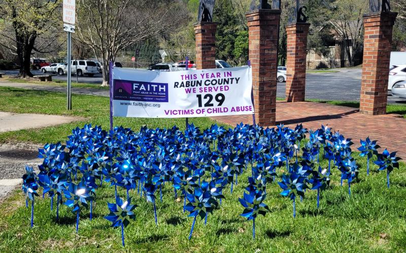 Megan Broome/The Clayton Tribune. Pinwheels on display in front of the Rabun County Courthouse represent 129 victims of child abuse who were served in Rabun County this year. Pinwheels are also on display at Rabun County Division of Family and Children Services.
