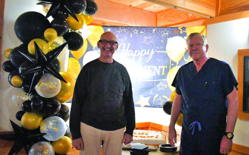 Megan Broome/The Clayton Tribune. Tiger Clinic is officially closing with the retirement of Dr. Guy Gober, left, who has been in Rabun County for 33-and-a-half years but has over 48 years of experience in the medical field. Dr. Stephen Jarrard, right, has been at Tiger Clinic for eight-and-a-half years and also practices in Stephens County. Dozens of people attended Gober’s retirement party Friday, March 31, that was filled with decorations.