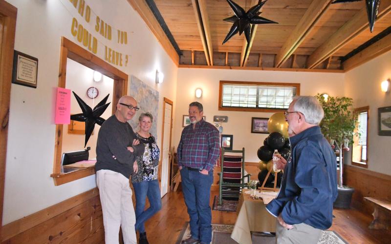 Megan Broome/The Clayton Tribune. Dr. Guy Gober, left, mingles with dozens of former and current coworkers, patients and community members at Tiger Clinic Friday, March 31, as they wish him well on his retirement and recollect on the memories they share and the impact Gober had on their lives.