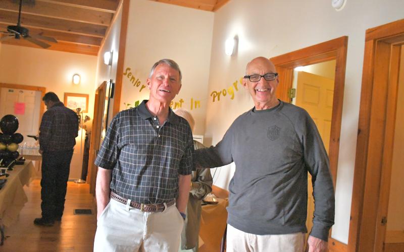 Megan Broome/The Clayton Tribune. Dr. Guy Gober, right, catches up with high school friend Bob Thompson during Gober’s retirement party held at Tiger Clinic Friday, March 31. Gober has been in Rabun County for 33-and-a-half years but has over 48 years of experience in the medical field.