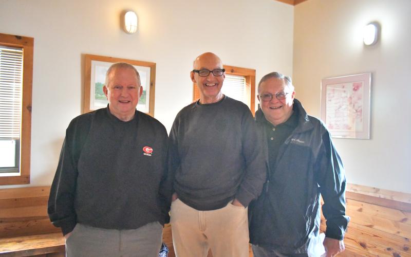 Megan Broome/The Clayton Tribune. Dr. Guy Gober, center, converses with Ed Gillespie, left, and Jim Gillespie at Gober’s retirement party at Tiger Clinic Friday, March 31. They recalled memories they had with Gober and how much he cared for his patients. Gober has been in Rabun County for 33-and-a-half years but has over 48 years of experience in the medical field.