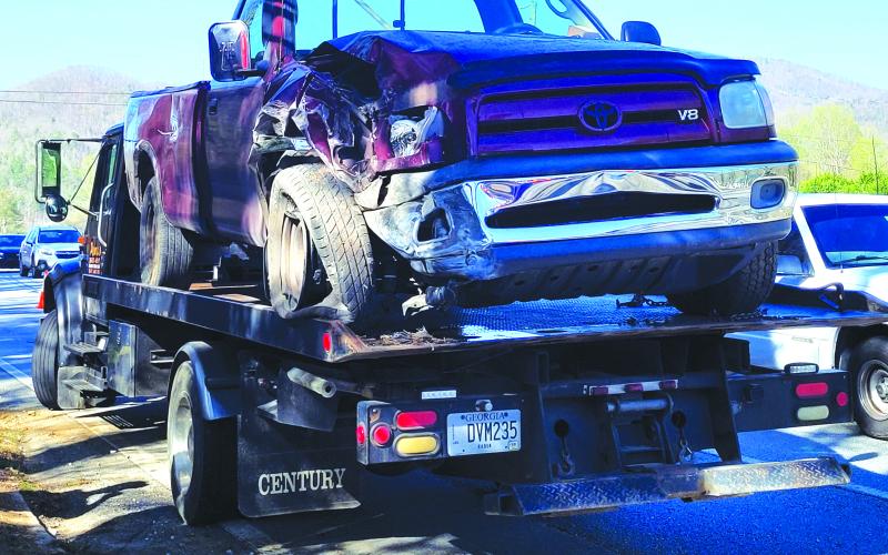 Megan Broome/The Clayton Tribune. This red 2006 Toyota Tundra, driven by a Mountain City man, went off the roadway in Mountain City, striking a power pole and concrete barrier.